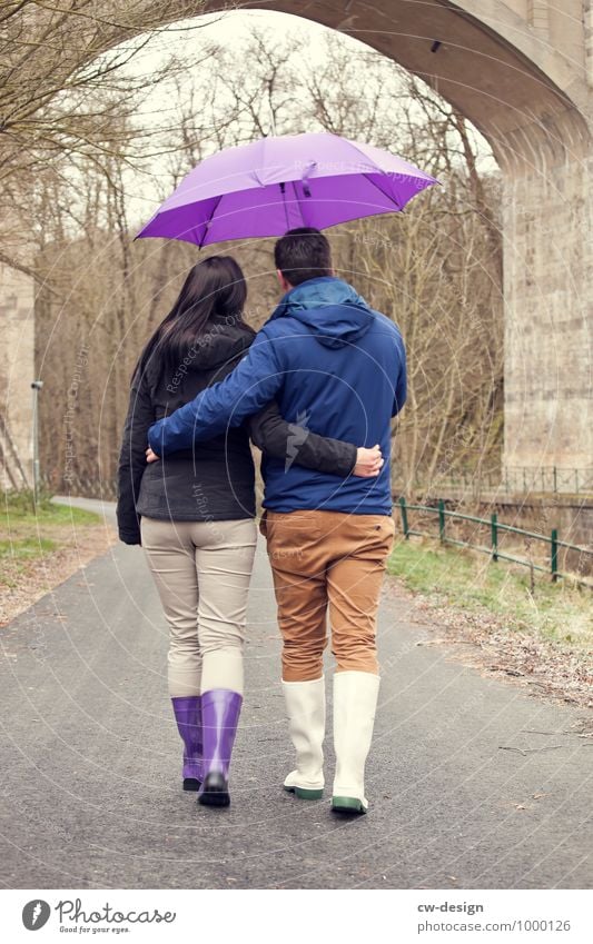 Couple walking down the street with umbrella in love Matrimony Husband Wife Wedding anniversary Wedding ceremony Wedding couple proximity Caresses