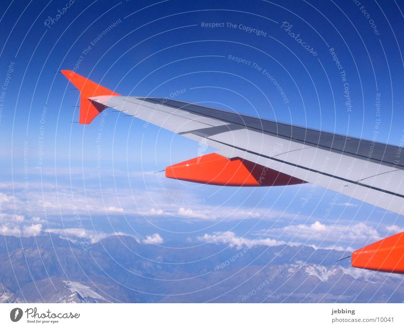 flapping Airplane Vantage point Clouds Sky Covers (Construction) Transport Wing Flying Far-off places Mountain Alps Jet