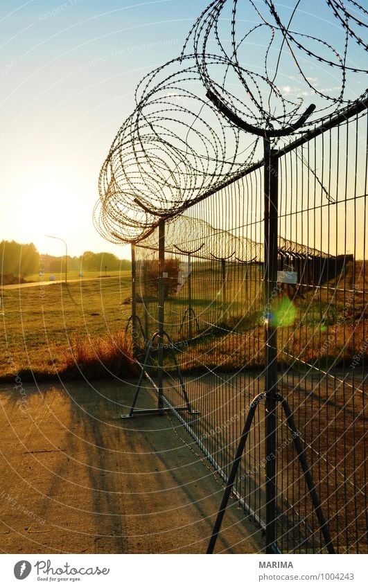barbed wire fence Landscape Threat Dangerous evening Barrier Fear outside threatening Dusk twilight dawn Metal military premises military area Barbed wire fence