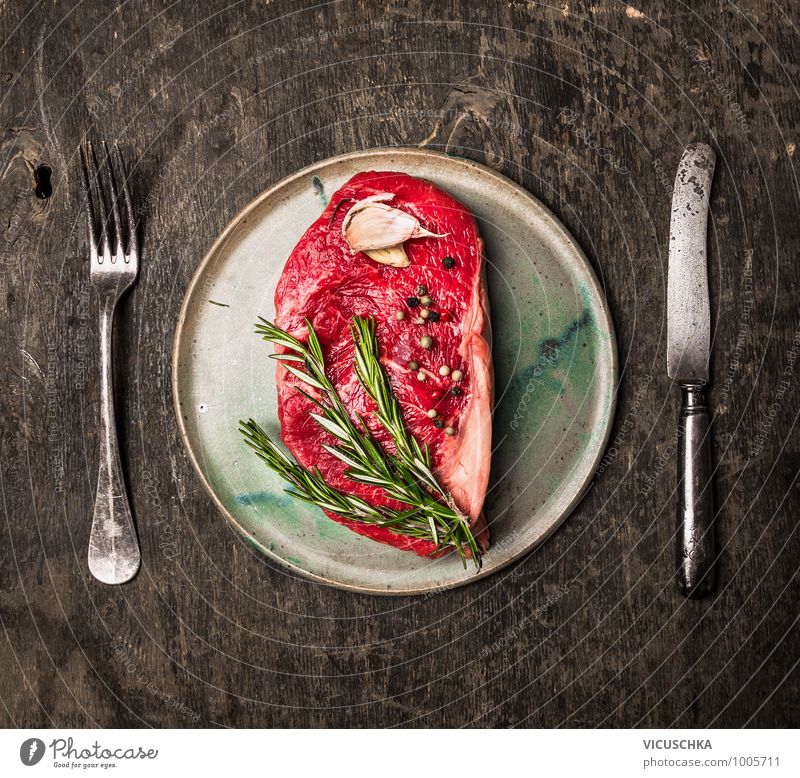 Roast beef steak raw on the plate with cutlery Food Meat Herbs and spices Nutrition Lunch Dinner Banquet Organic produce Diet Crockery Plate Knives Fork Style