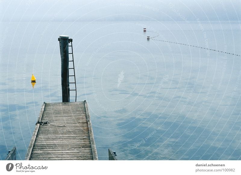 Nothing going on at the lake Lake Autumn Footbridge Fog Calm Horizon Buoy Gray Yellow Background picture Gloomy Grief Distress Blue Ladder Water