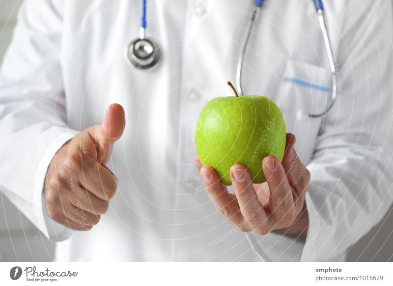 Doctor with green apple in hand in the consulting room Fruit Apple Health care Medical treatment Medication Hospital Masculine Man Adults Hand 1 Human being