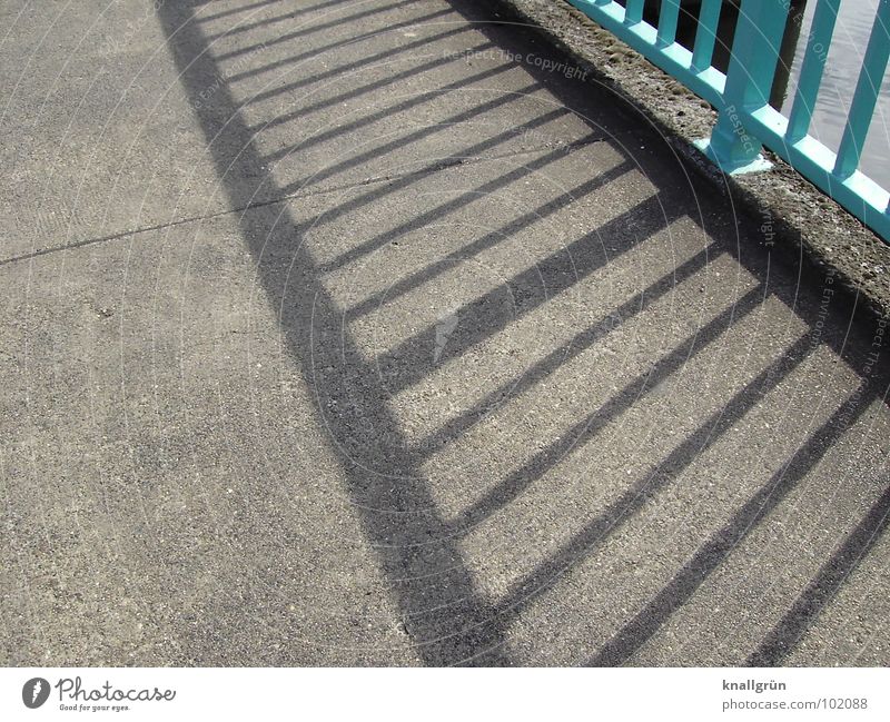 Where there is much light... Stripe Turquoise Light blue Asphalt Gray Bridge railing Summer's day Shadow Sun Lanes & trails To go for a walk