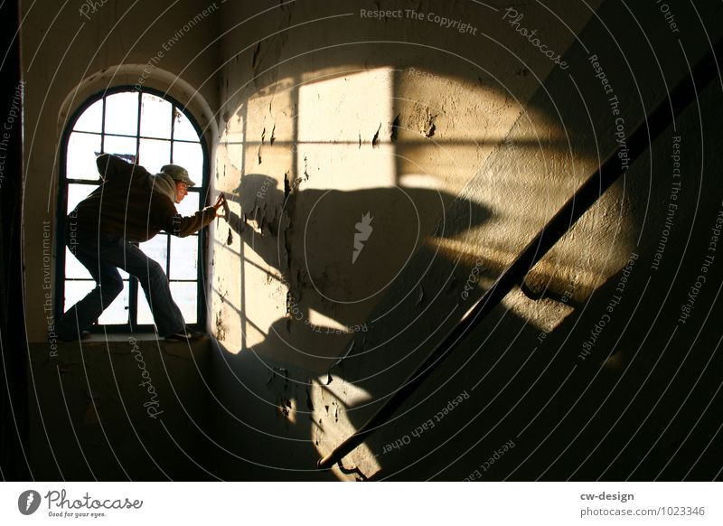 Teenager poses in the old window of the abandoned building person masculine Window Shadow play Staircase (Hallway) Dark somber take hold of sb./sth. younger