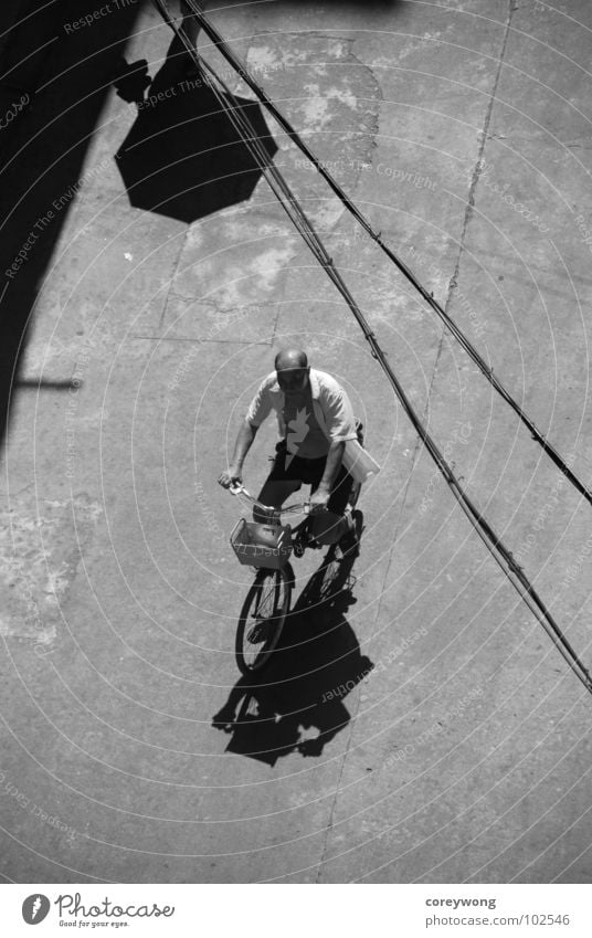 old man on bike Light Black & white photo Bicycle umbrella lines black and afternoon sun backlight shadow reminicent concrete almost riding alone company
