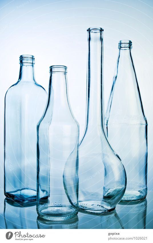Four empty glass bottles Glass Style Industry deal Packaging Utilize Clean Blue Purity Esthetic Design Sustainability Pure Recycling Empty