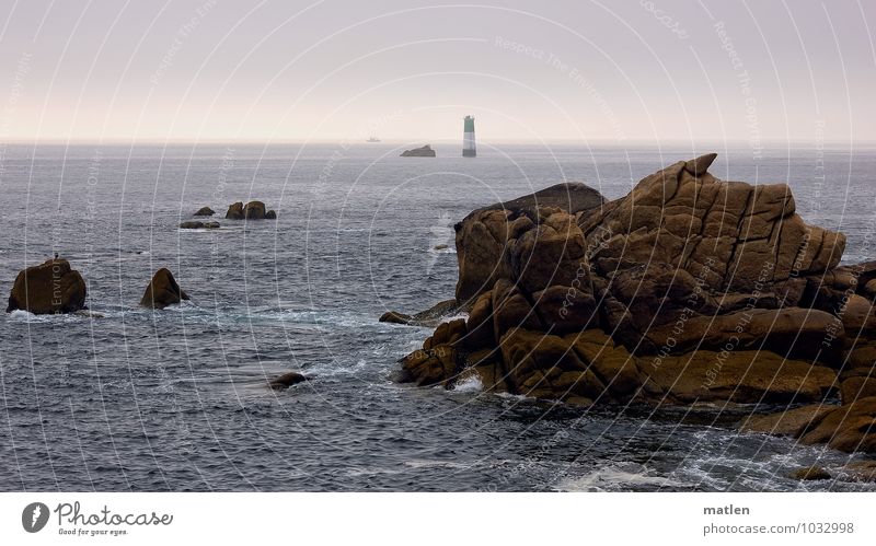 Lighthouse in the sea Nature Landscape Water Sky Cloudless sky Horizon Summer Weather Beautiful weather Rock Coast Reef Ocean Blue Brown Violet Colour photo