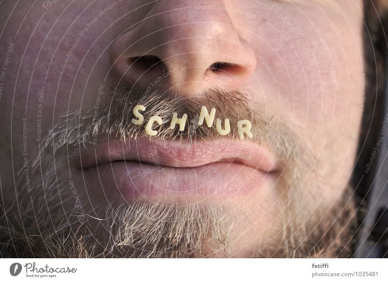 Man wears mustache Whisker Hair and hairstyles Letters (alphabet) Alphabet noodles spell Pelt Nose Characters Mouth Face Human being Facial hair Masculine Lips