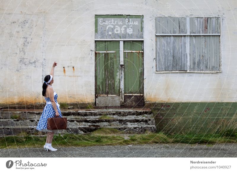 Young woman with suitcase in a dirndl in front of a closed location Lifestyle Going out Human being Feminine Woman Adults 1 45 - 60 years