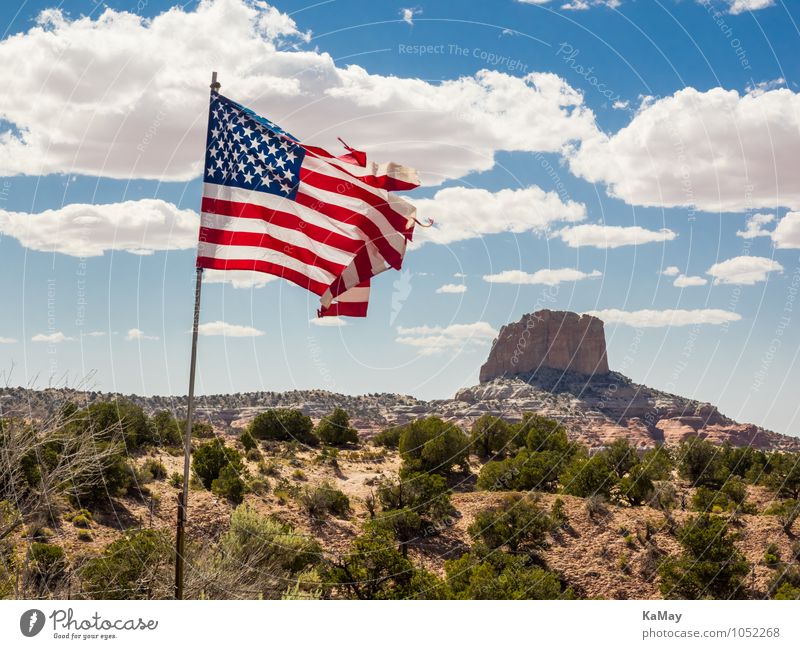patriotic hillock Nature Landscape Earth Sky Clouds Summer Beautiful weather Bushes Rock Deserted Tourist Attraction Landmark Stone Sand Flag Natural Blue Brown