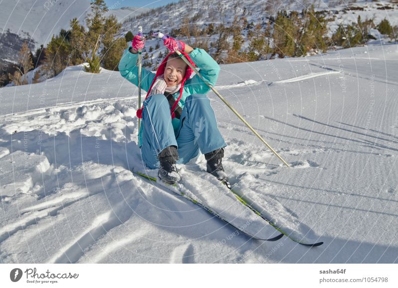 Young girl lifts up after the fall at Nordic ski resort Lifestyle Joy Relaxation Vacation & Travel Winter Snow Mountain Chair Sports Skiing Human being Girl