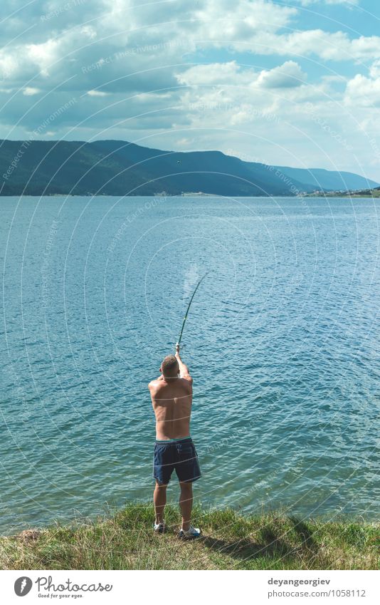 A Man with Fishing Rods Standing on the Beach · Free Stock Photo