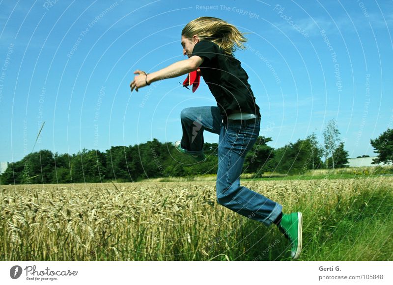 springtime Man Long-haired Blonde Denim blue Chucks Green T-shirt Black Field Wheat Wheatfield Jump Cornfield Edge Grass Blade of grass Ear of corn Mature