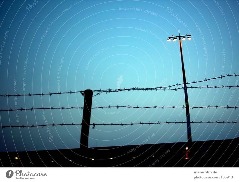 keep out Fence Barbed wire Light Floodlight Border Barrier Twilight Terrorism Dangerous National security Airport Aviation Fenced in safety area Threat