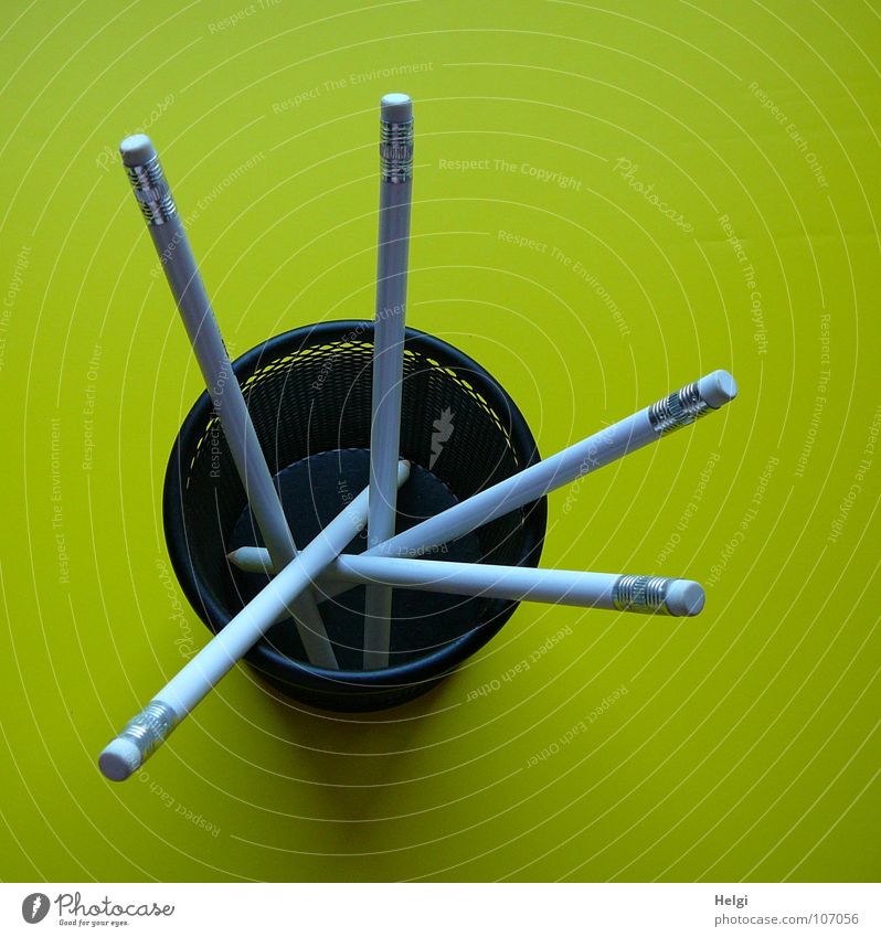 Pencils with erasers stand in a round box on a yellow background Eraser Mug Wire Round Long Thin Vertical Stand Muddled Side by side Consecutively