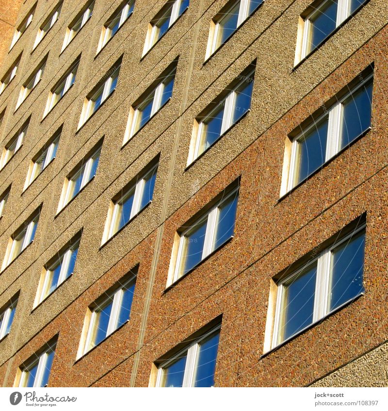 inconspicuous façade Architecture Prefab construction Facade Window Sharp-edged Hideous Gloomy Brown Norm Geometry Consecutively Classification GDR Diagonal