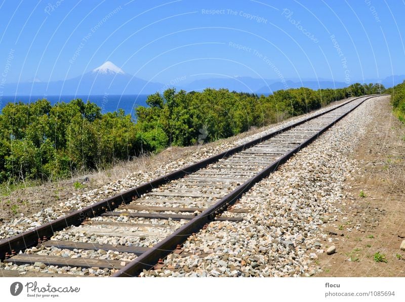 Railroad in front of volcano Osorno and lake Llanquihue Beautiful Vacation & Travel Tourism Adventure Summer Sun Island Snow Mountain Nature Sky Park Rock