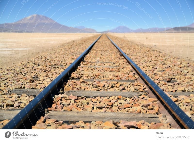 Endless train tracks in the desert with a volcano Vacation & Travel Trip Mountain Nature Landscape Sand Sky Horizon Volcano Transport Lanes & trails Railroad