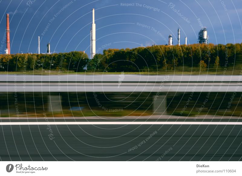 Industry Crash barrier Traffic lane Bushes Green Speed Wind Smoke Blue sky Movement Chimney Tall Exhaust gas Industrial Photography Motion blur Lane markings