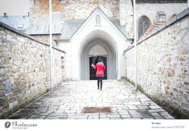 Woman with a red jacket walks towards the door of a monastery church Feminine Adults 1 Human being Old town Church Wall (barrier) Wall (building) Going Fresh
