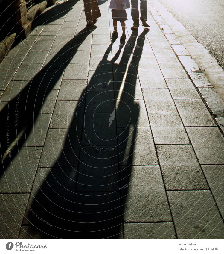 Afterwards Shadow play Back-light Sidewalk Family & Relations Footwear Forwards Curbside Sunlight Morning Hold hands Pursue Traffic infrastructure Trust Safety