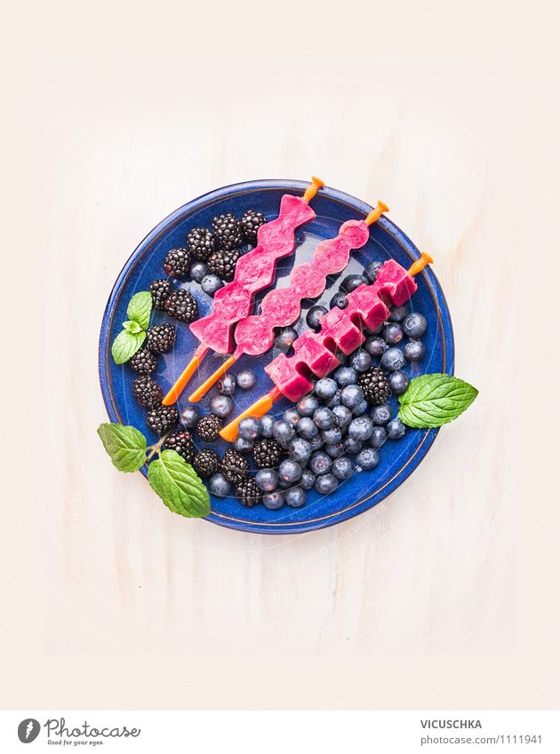 Fruit juice ice cream on a stem in blue plate with berries Food Dessert Nutrition Organic produce Vegetarian diet Diet Juice Plate Style Design Healthy Eating