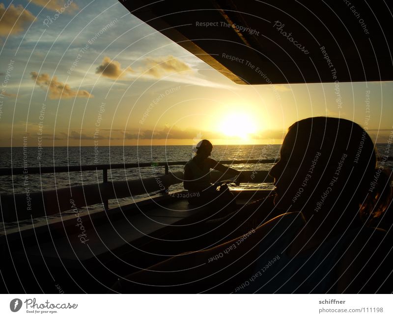 Sunset on board Watercraft Ocean Railing Evening sun Clouds Lake Indian Ocean Seychelles Horizon Woman Relaxation To enjoy Reading Vacation & Travel on deck