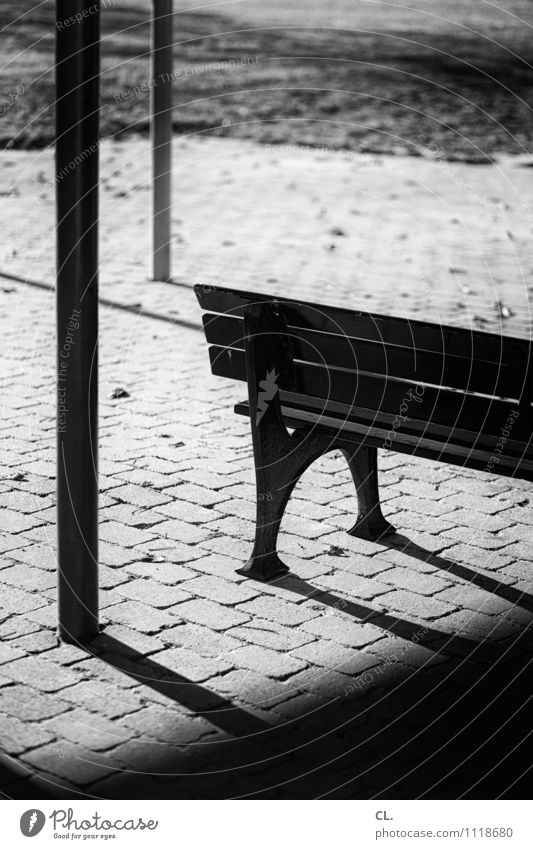 bench Meadow Ground Bench Wait Loneliness Stagnating Black & white photo Exterior shot Deserted Day Light Shadow Contrast Shallow depth of field