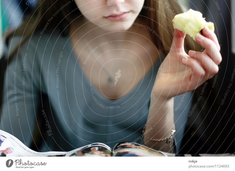 An apple a day Apple Nutrition Eating Finger food Lifestyle Leisure and hobbies Reading Girl Young woman Youth (Young adults) Face Hand 1 Human being
