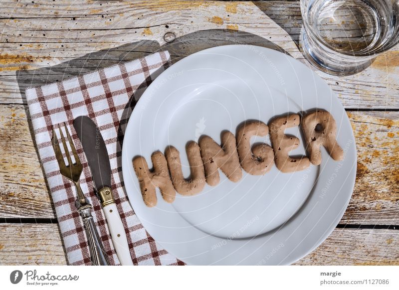 The letters HUNGER on a plate with knife and fork and napkin and a glass of water Nutrition Diet Fasting Appetite Beverage Cold drink Drinking water Plate Glass
