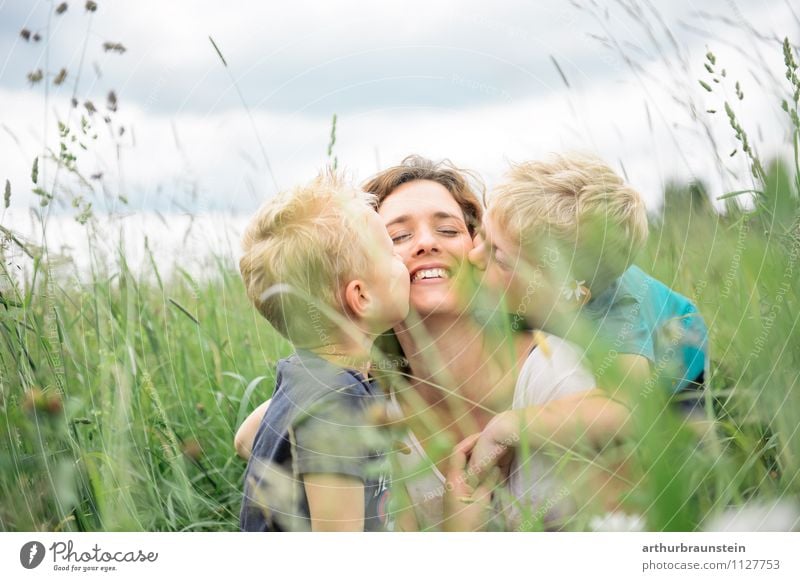 Children kiss their beloved smiling mommy in the high grass luck Leisure and hobbies Vacation & Travel Trip Summer Mother's Day Human being Masculine Feminine