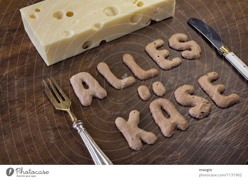 The letters ALL CHEESE on a rustic wooden board with a piece of hole - cheese and knife and fork Food Cheese Nutrition Breakfast Dinner Buffet Brunch Picnic