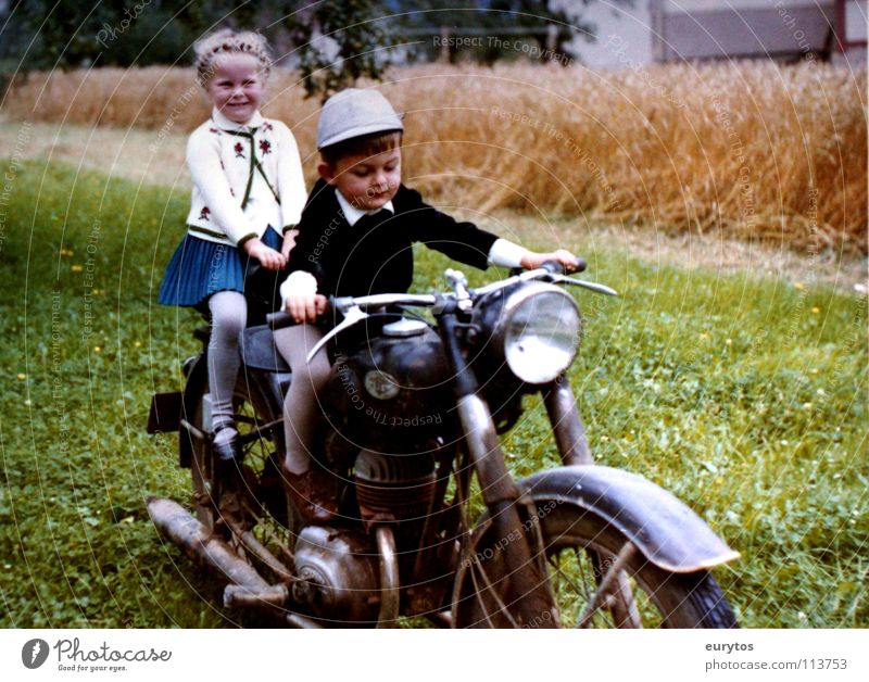 Economic Miracle Years... Colour photo Exterior shot Joy Lamp Child Girl Boy (child) Meadow Field Motorcycle Scooter Hat Green Peace Wheatfield