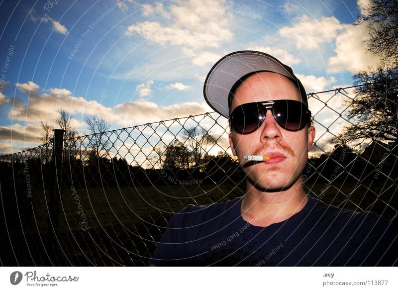 kalle smokes Moustache Upper lip Facial hair Pornography Eyeglasses Sunglasses East Wire netting Wire netting fence Fence Clouds Portrait photograph