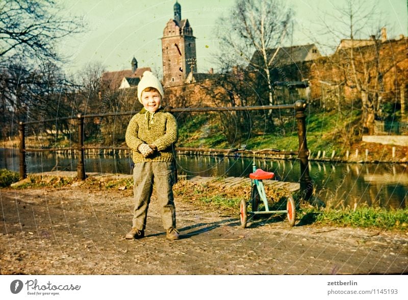 Child next to tricycle Family & Relations Family outing Domestic happiness Related Past Infancy Childhood memory Memory The fifties Sixties Fashion