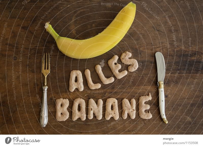 The letters ALL BANANANE with a banana and knife and fork on a rustic wooden table Food Fruit Nutrition Breakfast Lunch Dinner Buffet Brunch Picnic
