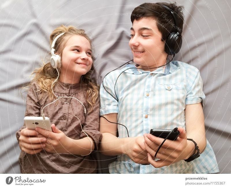 Top shot of brother and sister listening to music together from smartphones Joy Happy Music Girl Boy (child) Brothers and sisters Sister Family & Relations 2