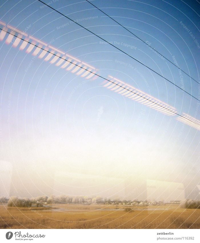 Rail journey to the north 5 Tree Bushes Winter Immature Railroad Train window Overhead line Light Lamp Reflection Driving Passage Transport Landscape Sky