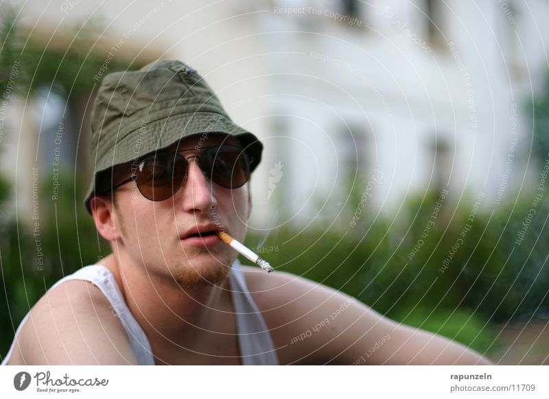 stereotype Man Antisocial Unshaven Sunglasses Porno glasses Cap Cigarette Fine rib Shirt Characteristic Corner of the mouth eugen Guy Hat Germany Cliche