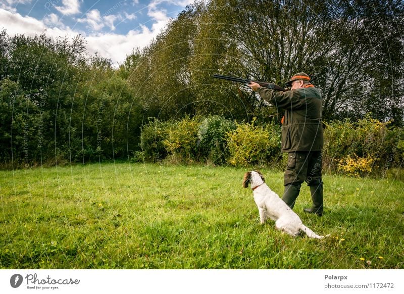 Hunter with a rifle Leisure and hobbies Playing Hunting Sports Human being Man Adults Nature Landscape Autumn Meadow Jacket Dog Wild Concentrate Scandinavia