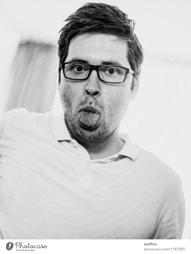 without words Masculine Man Adults 1 Human being 30 - 45 years Gray Funny Childlike Tongue Person wearing glasses polo shirt Black & white photo Interior shot