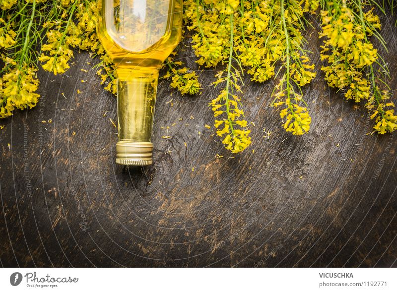 Rapeseed oil in glass bottle with fresh rape blossoms. Food Herbs and spices Cooking oil Nutrition Organic produce Vegetarian diet Diet Style Design