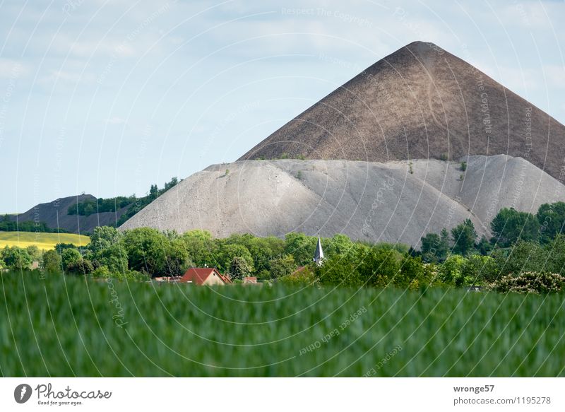 Houses and church of Volkstedt in front of the slag heaps of the mining in the Mansfeld mining district Mining Slagheap Refuse tip Saxony-Anhalt Germany Europe
