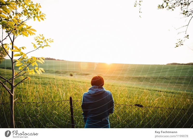 Young woman looking at a field in the evening sun Wellness Harmonious Well-being Contentment Relaxation Calm Meditation Vacation & Travel Far-off places Freedom