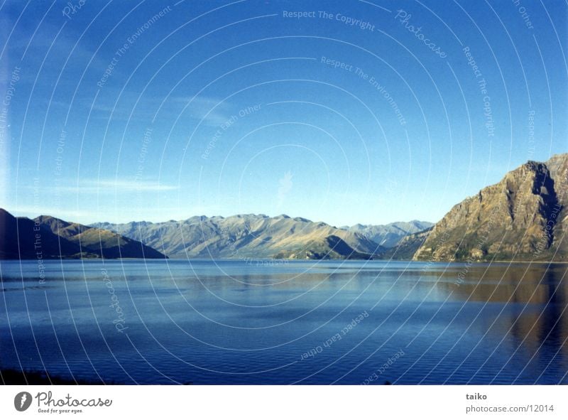 Lake Wanaka Beige New Zealand South Island Sky Nature Gray Clouds Beautiful weather Australia Mountain fawn mountains Water blue Landscape Stone Rock grey