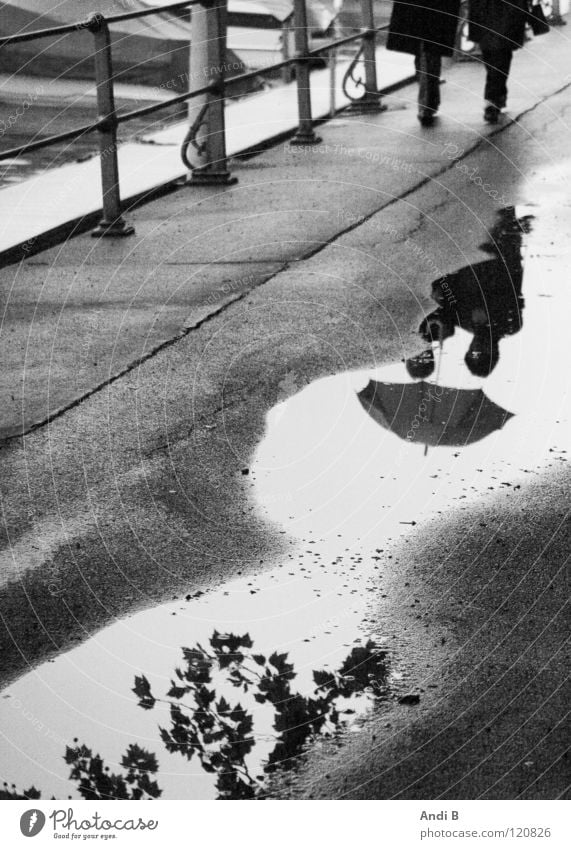 Walking in the rain To go for a walk Puddle Woman Reflection two people Black & white photo Reflections in the water Sadness