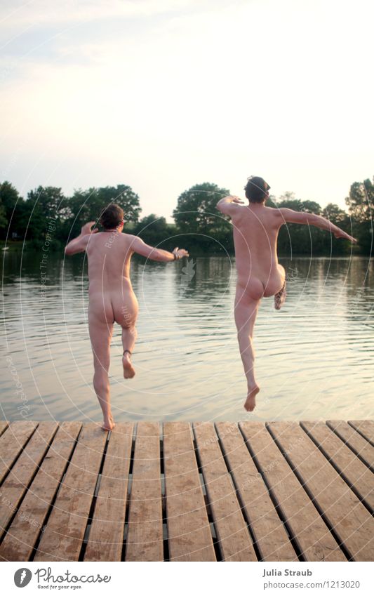 Two men jump naked from wooden jetty into swimming lake Masculine Man Adults Bottom 2 Human being 30 - 45 years Water Summer Beautiful weather Tree Lake