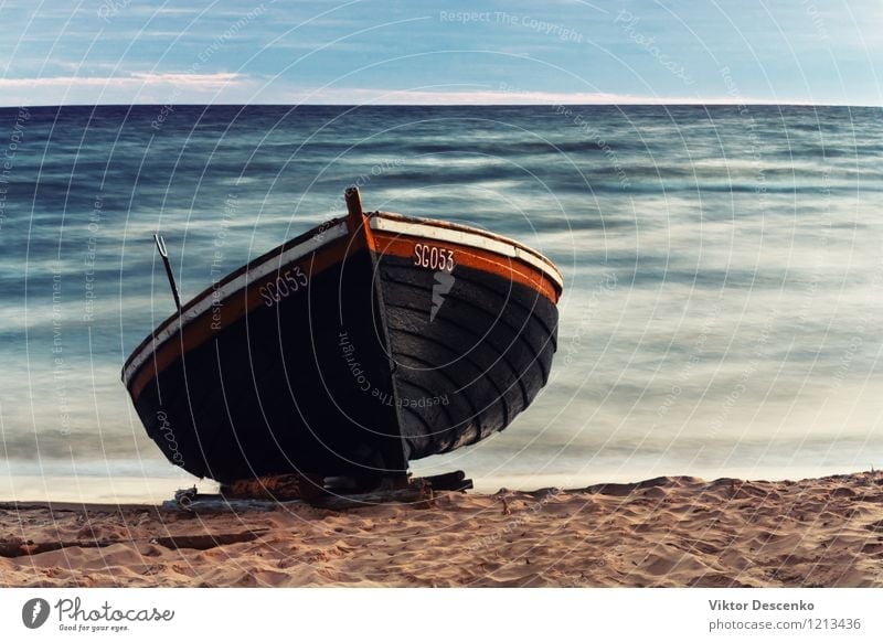 Wooden boat on the sandy shore - a Royalty Free Stock Photo from Photocase