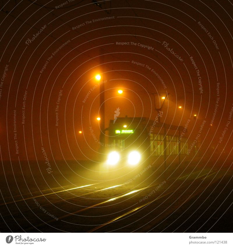 overnight express Tram Fog Railroad tracks Transport Means of transport Light Radiation Lantern Return Magdeburg Floodlight Logistics shuttle journey home