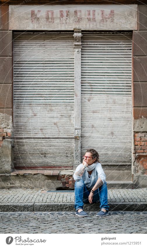 Young woman sitting on sidewalk in front of abandoned house Human being Youth (Young adults) Woman Adults Life 1 Village Small Town Old town